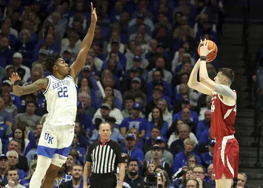 Kentucky's Amari Williams (22) defends against Arkansas' Zvonimir Ivisic, right, during the first half of an NCAA college basketball game in Lexington, Ky., Saturday, Feb. 1, 2025. (AP Photo/James Crisp)