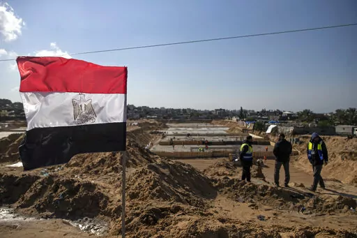Laborers work on concrete slab foundations for one of three Egyptian-funded housing complexes in the Gaza Strip, in the town of Beit Lahiya, northern Gaza, Tuesday, Jan. 25, 2022. After years of working behind the scenes as a mediator, Egypt is taking on a much larger and more public role in Gaza. In the months since it brokered a Gaza cease-fire last May, Egypt has sent crews to clear rubbled and promised to build vast new apartment complexes, and billboards of its president Abdel-Fattah el-Sis