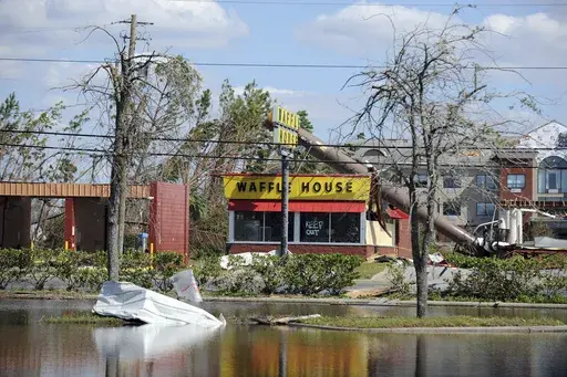 A billboard lies atop a Waffle House restaurant after being knocked down by Hurricane Michael in Panama City, Fla., Oct. 14, 2018. (Carlos R. Munoz/Sarasota Herald-Tribune via AP, File)
