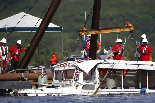 A duck boat that sank in Table Rock Lake in Branson, Mo., is raised July 23, 2018, after it went down several days earlier after a thunderstorm generated near-hurricane strength winds. A bill requiring stricter safety rules in response to the 2018 sinking of the tourist boat that killed 17 people passed the Senate on Thursday, Dec. 15, 2022, and will head to President Joe Biden. (Nathan Papes/The Springfield News-Leader via AP, File)