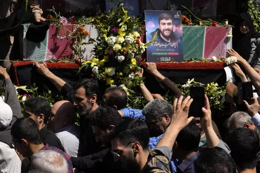 Iranian mourners try to touch the flag-draped coffins of Revolutionary Guard members killed in an airstrike widely attributed to Israel that destroyed Iran's Consulate in Syria on Monday, in a funeral procession in Tehran, Iran, Friday, April 5, 2024. The public funeral coincided with Iran's annual rally Quds Day, or Jerusalem Day, a traditional show of support for the Palestinians that has been held on the last Friday of the holy month of Ramadan since the 1979 Islamic Revolution. (AP Photo/Vah