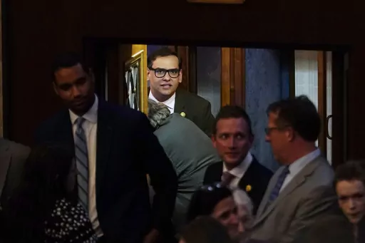 Rep. George Santos, R-N.Y., arrives at the House Chamber, Thursday, May 11, 2023, at the Capitol in Washington, as House Republicans are on track to pass a sweeping bill to build more U.S.-Mexico border wall and impose new restrictions on asylum seekers. (AP Photo/Jacquelyn Martin)