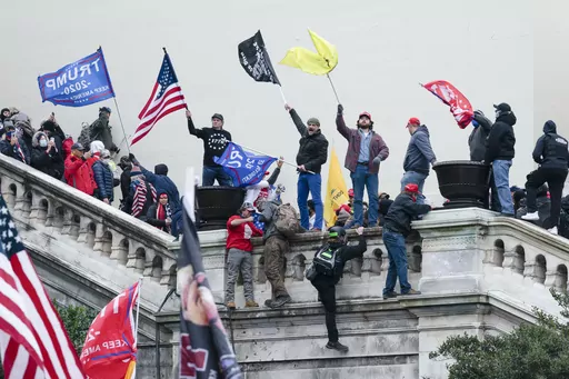 Rioters wave flags on the West Front of the U.S. Capitol in Washington on Jan. 6, 2021. (AP Photo/Jose Luis Magana, File)