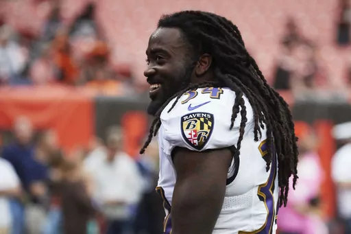 Baltimore Ravens running back Alex Collins attends during warmups prior to an NFL football game against the Cleveland Browns, Oct. 10, 2018, in Cleveland. Former NFL running back Collins, who played five seasons for the Seattle Seahawks and the Ravens after a terrific college career at Arkansas, has died. He was 28. The Seahawks released a statement from Collins' family that said he died Monday, Aug. 14, 2023. (AP Images/Rick Osentoski, File)