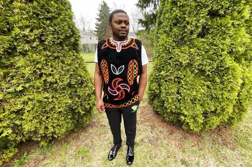 Wilfred Tebah, who fled Cameroon during its ongoing conflict, poses for a photo in the backyard of his home, Thursday, March 31, 2022, in Columbus, Ohio. African refugees say the recent decision to grant Ukrainians fleeing war refugee status and other humanitarian protections underscores the racial bias inherent in American immigration policy. Tebah says he and other immigrants from Cameroon have long been deserving of similar humanitarian considerations. (AP Photo/Patrick Orsagos)