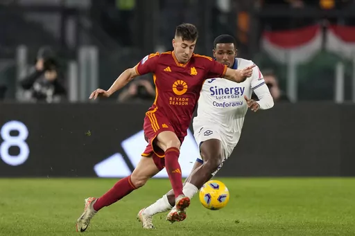 Roma's Stephan El Shaarawy, left, challenges for the ball with Verona's Jackson Tchatchoua during the Series A soccer match between Roma and Hellas Verona at the Rome Olympic stadium, Saturday, Jan. 20, 2024. (AP Photo/Andrew Medichini)