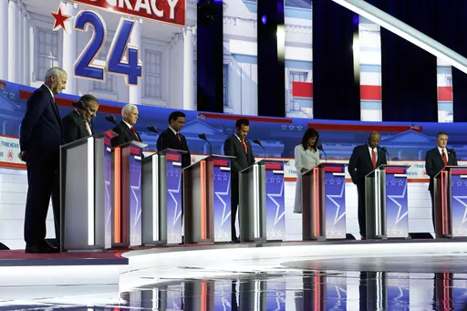 Republican presidential candidates, from left, former Arkansas Gov. Asa Hutchinson, former New Jersey Gov. Chris Christie, former Vice President Mike Pence, Florida Gov. Ron DeSantis, businessman Vivek Ramaswamy, former U.N. Ambassador Nikki Haley, Sen. Tim Scott, R-S.C., and North Dakota Gov. Doug Burgum stand on stage and listen to a prayer before a Republican presidential primary debate hosted by FOX News Channel, Wednesday, Aug. 23, 2023, in Milwaukee. (AP Photo/Morry Gash, File)