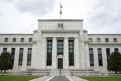 This May 4, 2021, file photo shows the Federal Reserve building in Washington. The Federal Reserve is poised this week to begin unleashing its most drastic steps in three decades to attack inflation by making it costlier to borrow — for a car, a home, a business deal, a credit card purchase — all of which will compound Americans' financial strains and likely weaken the economy. The Fed is expected to announce Wednesday, May 3, 2022 that it will begin quickly shrinking its vast stockpile of T
