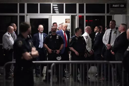 Former President Donald Trump is escorted to a courtroom, April 4, 2023, in New York. A federal judge has rejected Donald Trump's bid to move his hush-money criminal case from New York state court to federal court. He ruled that the former president had failed to meet a high legal bar for changing jurisdiction. (AP Photo/Mary Altaffer, File)