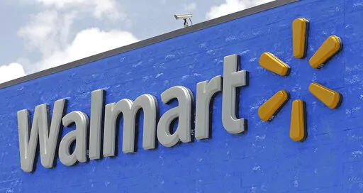 A Walmart sign displayed on the facade of a store in Hialeah Gardens, Fla., on June 1, 2017. Walmart is adding four new fulfillment centers to its existing capacity, a move that will bring more than 4,000 jobs and make next- or two-day shipping available to more Americans. (AP Photo/Alan Diaz, File)