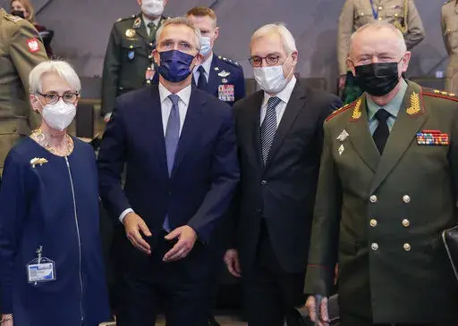 From left, United States Deputy Secretary of State Wendy Sherman, NATO Secretary General Jens Stoltenberg, Russia's Deputy Foreign Minister Alexander Grushko, and Russia's Deputy Defense Minister Alexander Fomin pose for a photo prior to the NATO-Russia Council at NATO headquarters, in Brussels, Wednesday, Jan. 12, 2022. Senior NATO and Russian officials are meeting Wednesday to try to bridge seemingly irreconcilable differences over the future of Ukraine, amid deep skepticism that Russian Presi