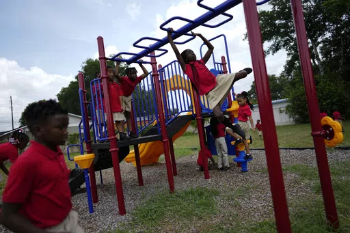 Students from Thomas Leadership Academy play on the school's playground in Eatonville, Fla., Aug. 23, 2023. Seventy years after the Supreme Court's Brown v. Board, America is both more diverse — and more segregated. (AP Photo/Rebecca Blackwell, File)