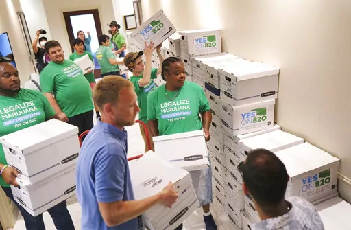Oklahomans for Sensible Marijuana Laws delivers more than 164,000 signatures to the Office of the Secretary of State at the Oklahoma state Capitol in Oklahoma City, July 5, 2022. Oklahoma Gov. Kevin Stitt on Tuesday, Oct. 18, 2022, set a special statewide election for March 7 for voters to decide whether to legalize the recreational use of marijuana. (Doug Hoke/The Oklahoman via AP, File)