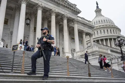 A U.S. Capitol Police officer stands watch as lawmakers leave the House of Representatives after voting on an interim spending bill to avoid a government shutdown next week, at the Capitol in Washington, Wednesday, Sept. 25, 2024. (AP Photo/J. Scott Applewhite)