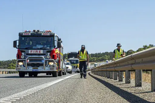 In this photo provided by the Department of Fire and Emergency Services, its members search for a radioactive capsule believed to have fallen off a truck being transported on a freight route on the outskirts of Perth, Australia, Saturday, Jan. 28, 2023. A mining corporation on Sunday apologized for losing the highly radioactive capsule over a 1,400-kilometer (870-mile) stretch of Western Australia, as authorities combed parts of the road looking for the tiny but dangerous substance. (Department 