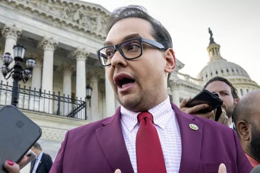 Rep. George Santos, R-N.Y., speaks to reporters outside the Capitol, in Washington, May 17, 2023. Santos, 34, has spent weeks fighting efforts by news outlets to unseal the names of the two people who co-signed the $500,000 bond, which enabled his pretrial release as he awaits federal charges of fraud, money laundering and theft of public funds. (AP Photo/J. Scott Applewhite, File)
