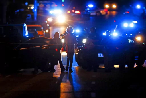 Police officers work at the scene of an active shooter on Poplar Avenue in Memphis, Tenn., Wednesday, Sept. 7, 2022. On Thursday, Sept. 13, 2022, police revised the number of people killed in a man's shooting rampage from four to three after a different suspect was identified in the slaying of a teenager during the tense ordeal in Memphis. (Mark Weber/Daily Memphian via AP, File)
