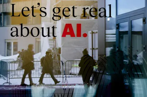 People are reflected in a window of a hotel at the Davos Promenade in Davos, Switzerland, Jan. 15, 2024. The artificial intelligence startup Perplexity AI has raised tens of millions of dollars from the likes of Jeff Bezos and other prominent tech investors for its mission to rival Google in the business of searching for information. (AP Photo/Markus Schreiber, File)