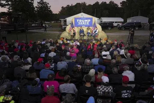Donald Trump Jr., former Democratic Rep. Tulsi Gabbard and Sen. Markwayne Mullin, R-Okla, speak during a campaign event in support of Republican presidential candidate former President Donald Trump, Oct. 18, 2024, in Red Springs, N.C. (AP Photo/David Yeazell)