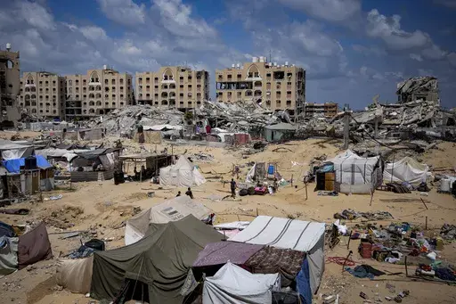 Palestinians displaced by the Israeli air and ground offensive on the Gaza Strip flee from Hamad City, following an evacuation order by the Israeli army to leave parts of the southern area of Khan Younis, Sunday, Aug. 11, 2024. (AP Photo/Abdel Kareem Hana)