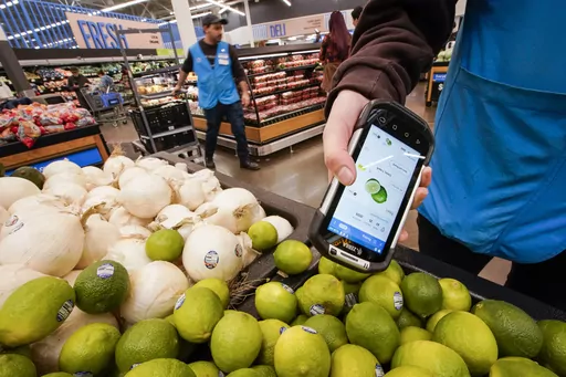 A worker scans onions, limes and other produce inside the Walmart Supercenter in North Bergen, Thursday, Feb. 9, 2023, in New Jersey. Walmart reported a strong first quarter, Thursday, May 18, and boosted its outlook for the year as the nation’s largest retailer continues to draw budget conscious consumers in a challenging economic environment. (AP Photo/Eduardo Munoz Alvarez, File)