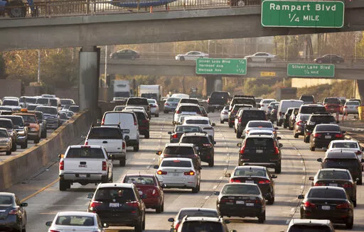 This Dec. 12, 2018, file photo shows traffic on the Hollywood Freeway in Los Angeles. New vehicles sold in the U.S. will have to travel an average of at least 40 miles per gallon of gasoline in 2026 under new rules unveiled by the government. The National Highway Traffic Safety Administration said Friday its fuel economy requirements will undo a rollback enacted under President Donald Trump. (AP Photo/Damian Dovarganes, File)