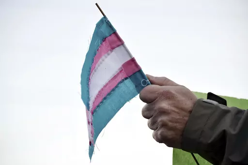 A person holds a transgender flag to show their support for the transgender community during the sixth annual Transgender Day of Remembrance at Maryville College, Nov. 20, 2016, in Maryville, Tenn. According to court documents filed Wednesday, Nov. 1, 2023, the American Civil Liberties Union and attorneys representing Tennessee transgender teens and their families have asked the U.S. Supreme Court to block a ban on gender-affirming care for minors that a lower court allowed to go into effect. (B