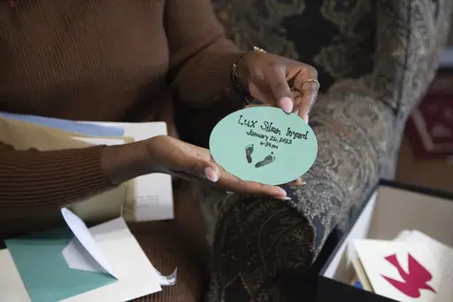 Doneysha Smith shows the footprints of her 18-week-old baby Lux Siloam at her home in Sherwood, Arkansas, Tuesday, Feb. 11, 2025. After being stillborn at 18 weeks, Lux's body was stolen and sold to traffickers in two states, prompting an FBI investigation. A proposed law, known as Lux's Law, would prohibit the sale of dead bodies that were intended to be cremated or buried and establish penalties in Arkansas. (AP Photo/Katie Adkins)