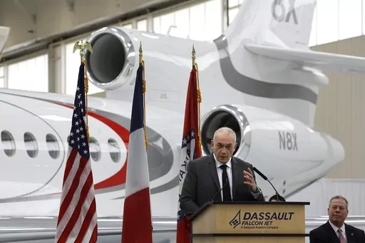 Dassault Falcon CEO Thierry Betbeze talks about the Dassault expansion as Jay Cheshire, right, president of the Little Rock, Ark., Regional Chamber of Commerce, looks on during an event at the Dassault hangar at Bill and Hillary Clinton National Airport, Tuesday, Dec. 12, 2023, in Little Rock. Dassault Falcon Jet on Tuesday announced a $100 million expansion of its facility in Little Rock that the jet manufacturer said will add 800 new jobs. (Thomas Metthe/Arkansas Democrat-Gazette via AP)