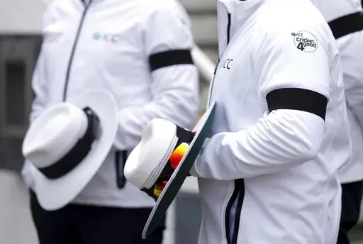 Umpires wearing black armbands on day three of the third LV= Insurance Test match at the Kia Oval, following the death of Queen Elizabeth II, Saturday September 10, 2022.  (John Walton/PA via AP)