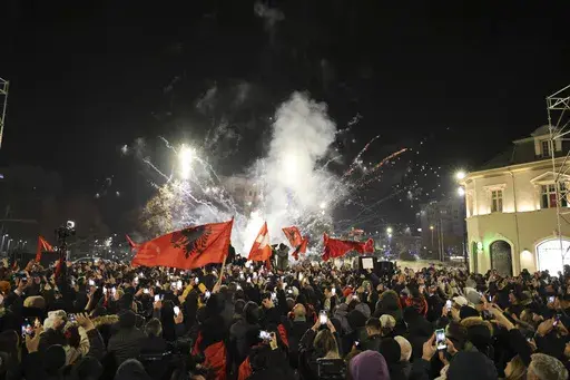 Supporters of left-wing Vetevendosje! party celebrate following results of a parliamentary election, in Pristina, Kosovo, Monday, Feb. 10, 2025. (AP Photo/Vlasov Sulaj)
