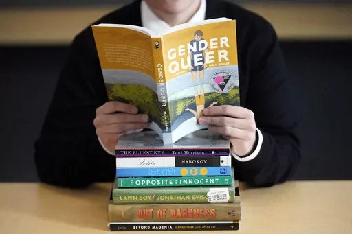 A pile of challenged books appear at the Utah Pride Center in Salt Lake City on Dec. 16, 2021. Attempted book bannings and restrictions at school and public libraries continue to surge, according to a new report from the American Library Association. (AP Photo/Rick Bowmer, File)