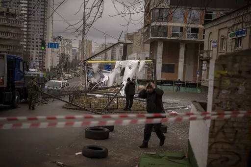 Police officers inspect area after an apparent Russian strike in Kyiv Ukraine, Thursday, Feb. 24, 2022. On the battlefields of Ukraine, the fog of war plagues soldiers. A related issue afflicts those who are far from the fighting but avid to learn developments in the vast war. Disinformation, misinformation and absent information all cloud civilians’ understanding. Officials from each side denounce devious plots being prepared by the enemy, which never materialize. They claim victories that ca