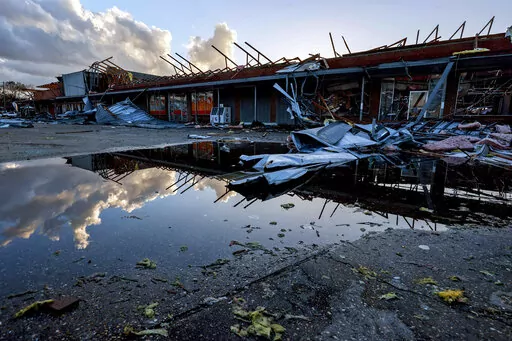 The roof of a local businesses is strewn about after a tornado passed through Selma, Ala., Thursday, Jan. 12, 2023. (AP Photo/Butch Dill)