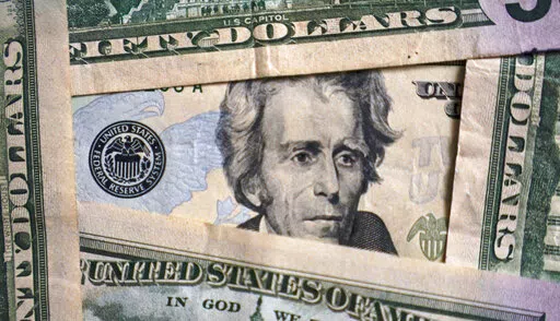 Photo of Andrew Jackson on a $20 bill is shown, Friday, Jan. 28, 2022, in Cleveland.  Worrying about overall financial issues can make people less likely to plan for retirement, according to a 2021 report.  If you don’t have enough saved for your golden years, it could mean retiring later than you planned or running out of money during retirement. (AP Photo/Tony Dejak, File)