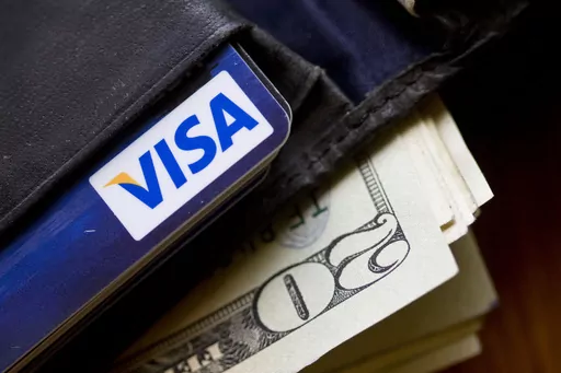 In this Feb. 2, 2011, file photo, a wallet containing cash and a Visa card is displayed in Surfside, Fla. After a summer that might have included more spending than usual, a fall financial cleanse could get you back on track. You can start with looking back at your January goals and doing a simple financial audit. Then if you’re not already following a budget, create one to track your spending, and make checking finances part of your morning routine. The cleanse could also include a plan to pa
