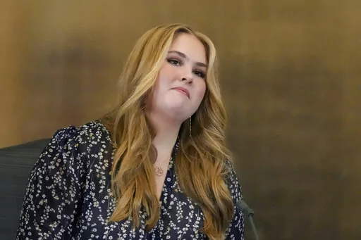 Heir to the Dutch throne Princess Amalia speeches as she takes an honorary seat at the Council of State, the highest government advisory body in The Hague, Netherlands, Wednesday, Dec. 8, 2021, one day after celebrating her eighteenth birthday. The heir to the Dutch throne has been forced to turn her back on student life in Amsterdam and continue living at home in her parents' palace in The Hague, in the latest evidence of the threat of violent organized crime gangs to Dutch society. (AP Photo/P