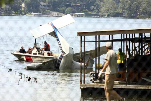 Multiple agencies, including the Garland County Sheriff's Office, the Lake Hamilton Fire Department, and Piney Fire Department, work Tuesday, June 27, 2023, with a private contractor, Dawson Aircraft Inc. of Clinton, Ark., to recover an aircraft that crashed into Lake Hamilton in Hot Springs, Arkansas, on Monday, June 26. (James Leigh/The Sentinel-Record via AP)