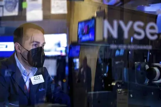 In this photo provided by the New York Stock Exchange, trader Robert Greason works on the floor, Friday, June 3, 2022. U.S. stocks are falling Friday as Wall Street focuses on the downside of the still-strong U.S. jobs market. (Allie Joseph/New York Stock Exchange via AP)
