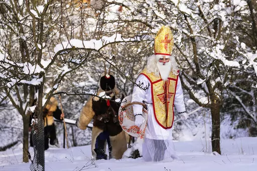 Revelers take part in a traditional St. Nicholas procession in the village of Lidecko, Czech Republic, Monday, Dec. 4, 2023. Nicholas was a fourth century Catholic bishop from the Mediterranean port city of Myra (in modern-day Turkey). “Much of the rest is legend. There’s not really a lot of hard historical evidence about St. Nicholas,” said the Rev. Nicholas Ayo, author of “Saint Nicholas in America: Christmas Holy Day and Holiday.” (AP Photo/Petr David Josek, File)